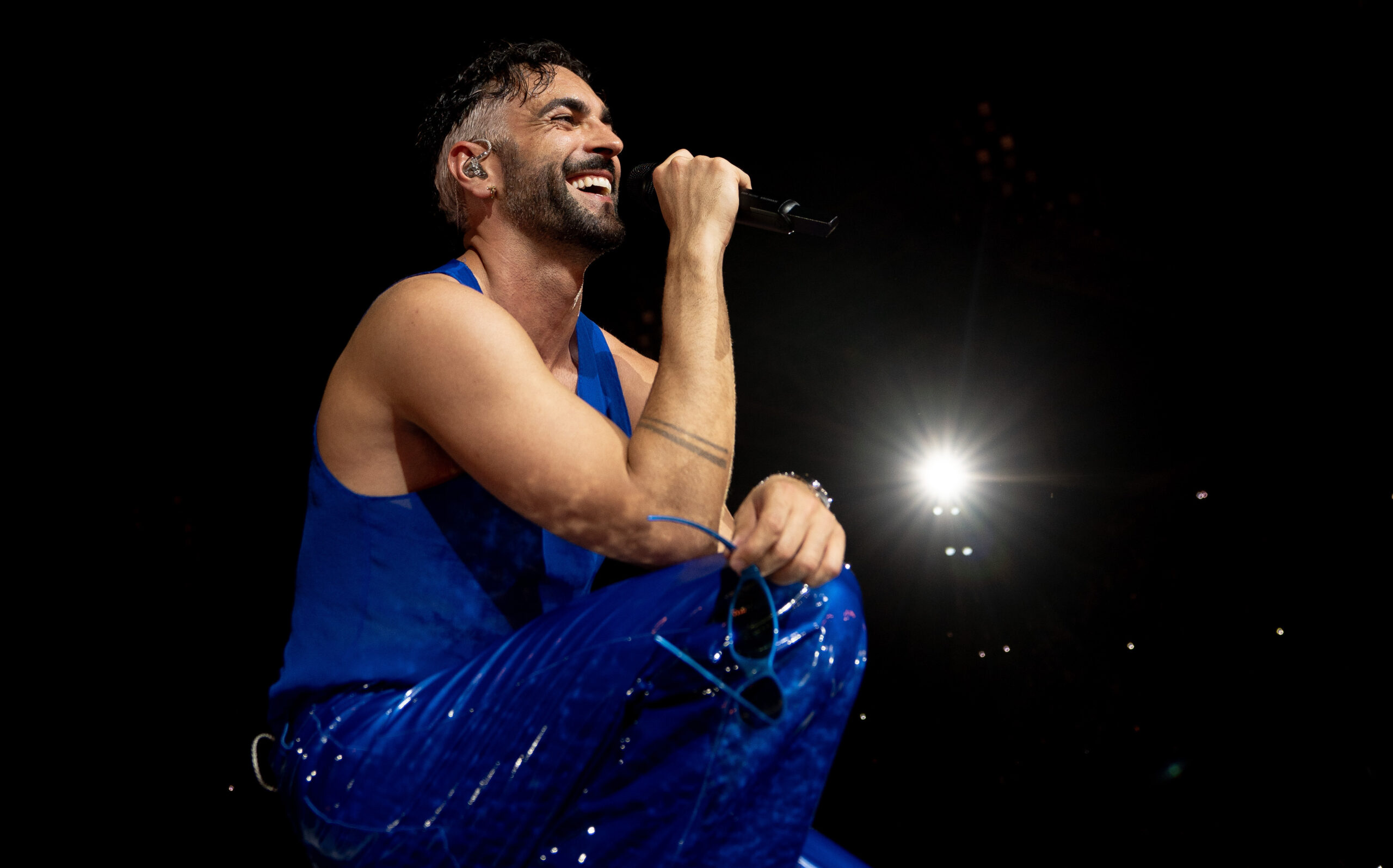 Marco Mengoni in concerto attraversa il dolore del buio e del lutto, si rimbocca le maniche nella rinascita e oltrepassa i confini per sentirsi vivo (sì, ci entrano anche i corsetti): “Se non sono me stesso ora, forse non lo sarò mai più”